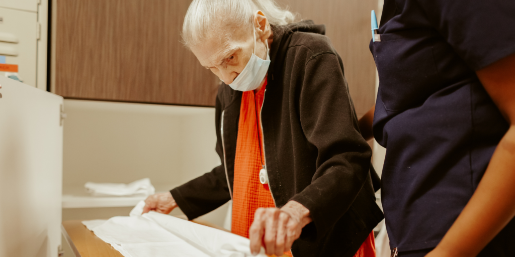 Occupational therapist with a short stay rehab patient practicing activities of daily living to prepare for aging in place at home